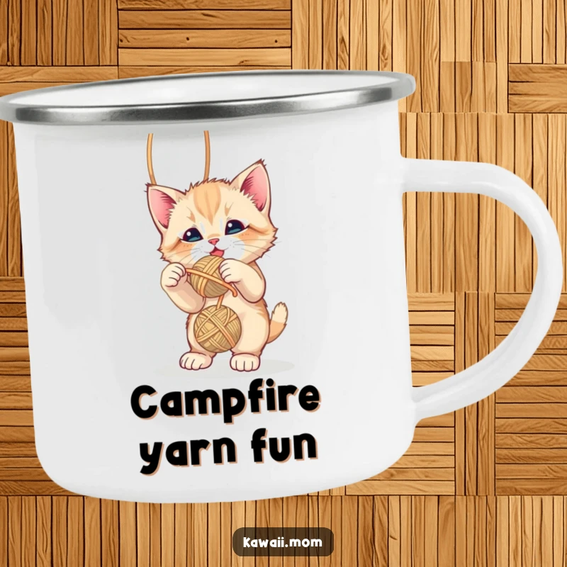Funny cute kitten playfully batting at a dangling yarn ball on a sturdy camping mug, ideal for outdoor fun, a gift.