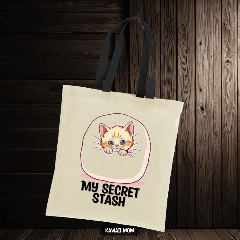 Funny kitten tote bag with a playful cat peeking from behind a soft cushion, perfect for humorous and stylish errands.